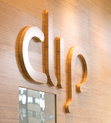 Plexwood® Clip unique shop wall and logo with warm design veneer of reversed plywood edges in beech