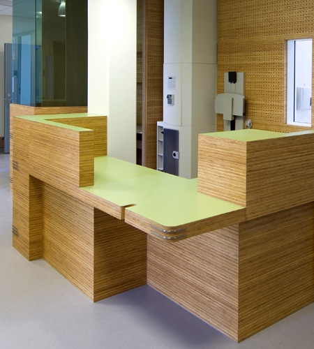 Plexwood® St. Olav's reception with cnc routed acoustic perforations wall paneling in reversed glued pine plywood