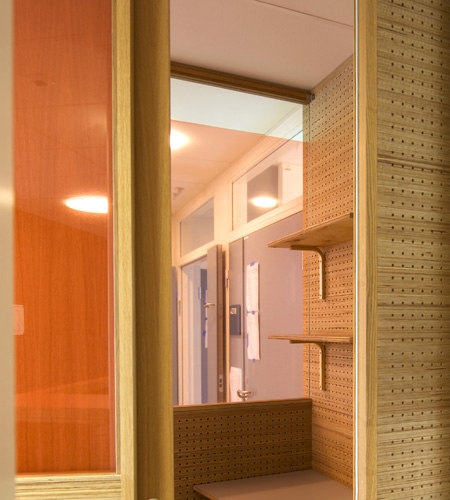 Plexwood® St. Olav's hospital telephone office cabinet detail with cnc perforated acoustic wall in pine end-glued plywood