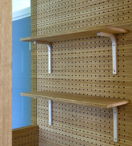 Plexwood® St. Olav's detail of a wall from cnc perforated acoustic panels in natural pine smart composite ply