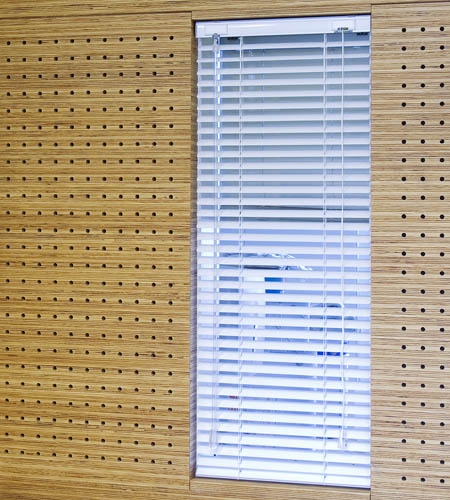 Plexwood® St. Olav's wall detail of cnc perforated acoustic veneer wood panels in pine with internal window