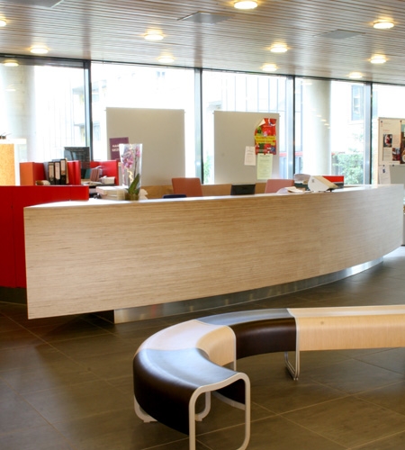 Plexwood® Zeeburg City District Office entrance service desk frontal view in birch reverse glued-up veneer plywood