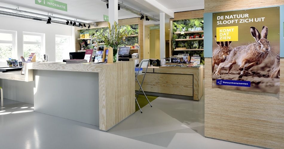 Plexwood® Nature Monuments visitor's information center desk, displays, wall and tables in vice versa pine