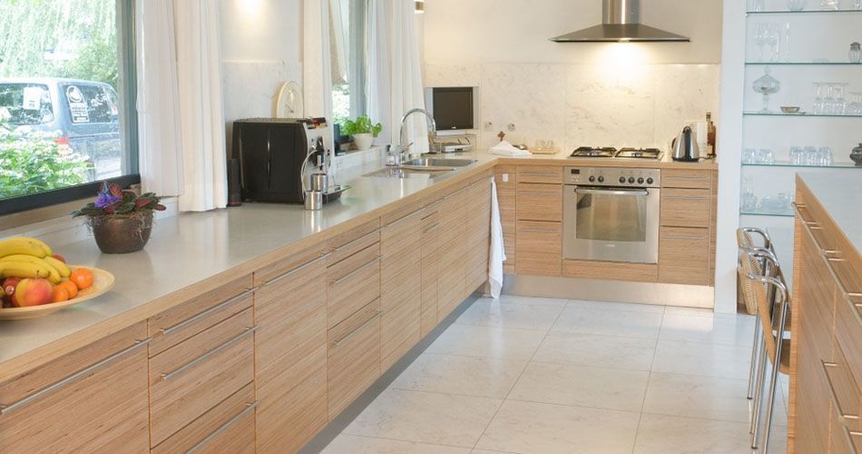 Plexwood® Eat-in kitchen overview with kitchen cabinetry in natural birch re-stacked plywood veneer
