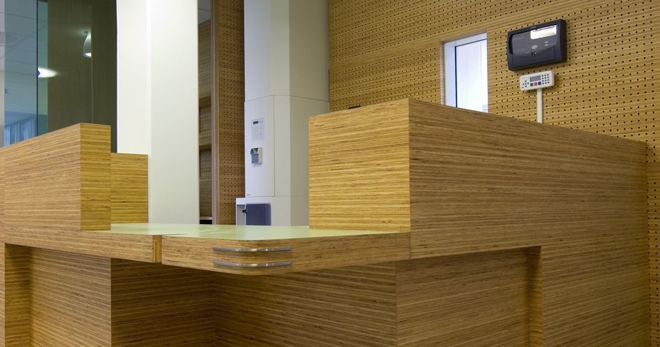 Plexwood® St. Olavs reception desk detail with cnc routed acoustic perforations back wall paneling in pine