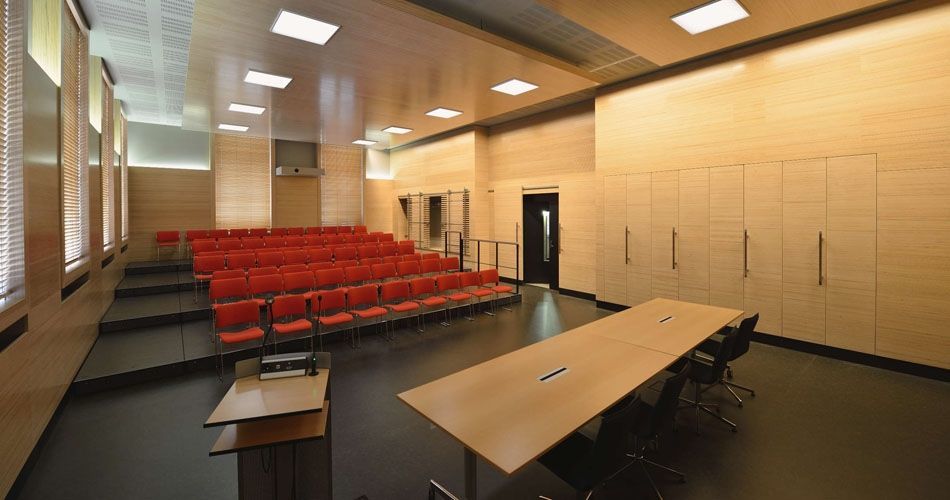 Plexwood® WBG Erfurt wall paneling with feature sliding doors and ceiling islands with integrated lights in beech
